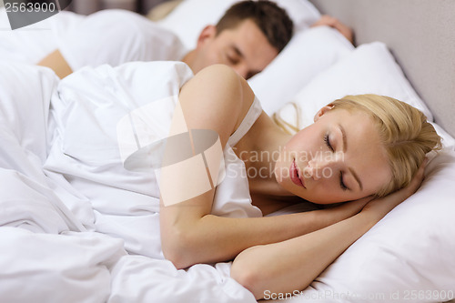 Image of happy couple sleeping in bed