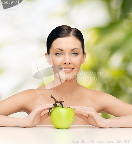 Image of beautiful woman with green apple