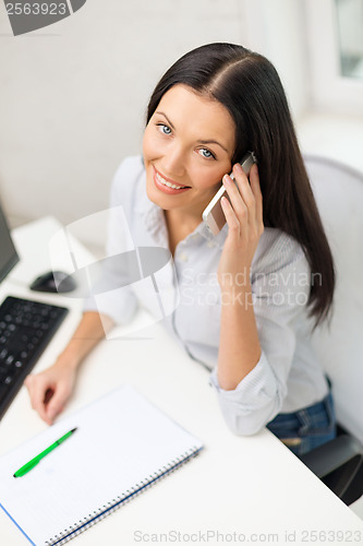 Image of smiling businesswoman or student with smartphone