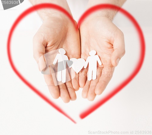 Image of man hands with paper men