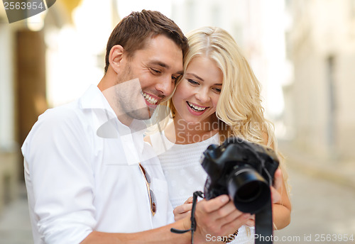 Image of smiling couple with photo camera