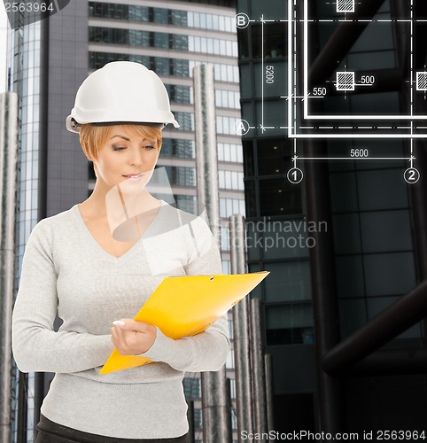 Image of female contractor in white helmet with files