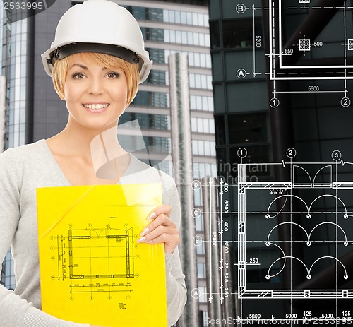 Image of female contractor in white helmet with files