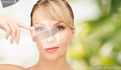 Image of beautiful woman touching her eye area