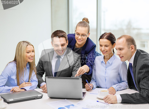 Image of business team with laptop having discussion