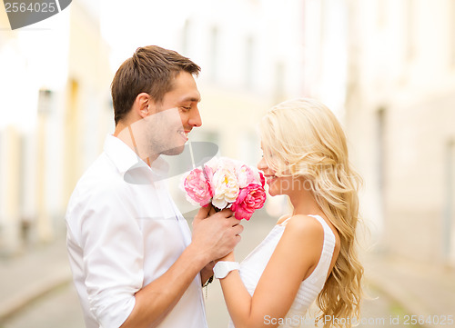 Image of couple with flowers in the city