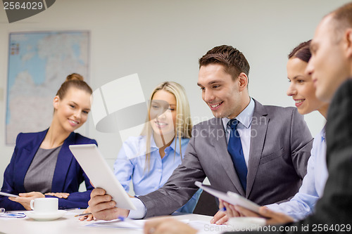 Image of business team with tablet pc having discussion