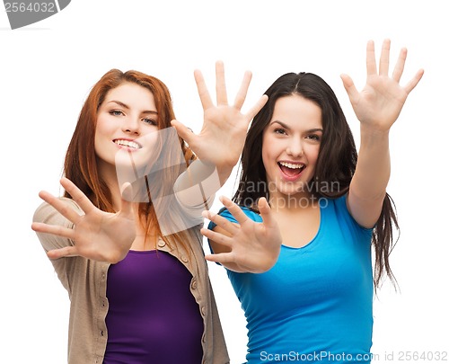 Image of two smiling girls showing their palms