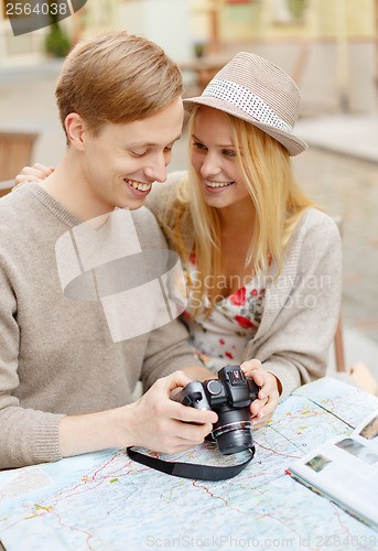 Image of smiling couple with photo camera