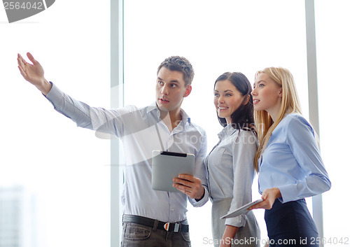 Image of business team working with tablet pcs in office