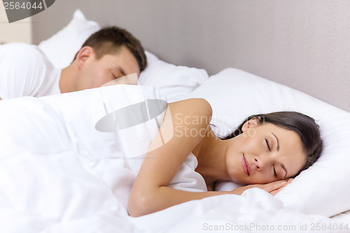 Image of happy couple sleeping in bed