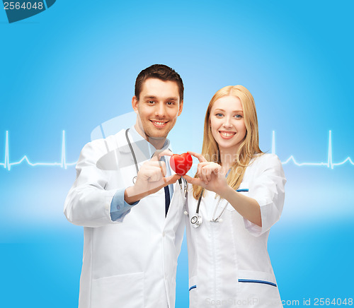 Image of smiling doctors cardiologists with heart