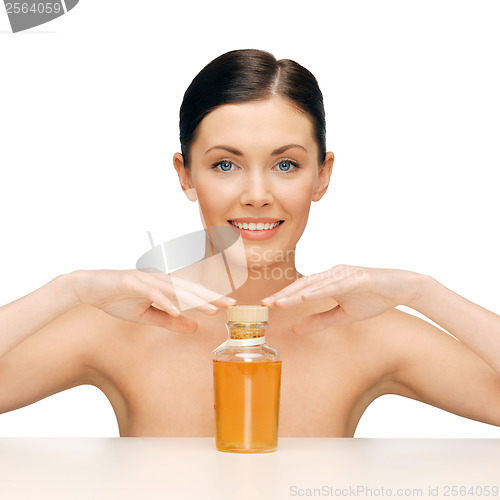 Image of beautiful woman with oil bottle