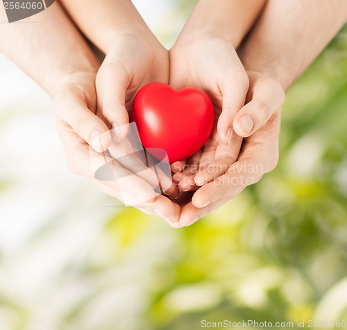 Image of woman and man hands with heart