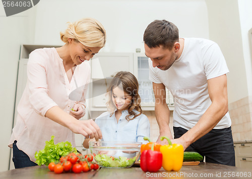 Image of happy family making dinner in kitchen