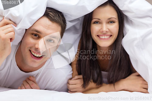 Image of happy couple sleeping in bed