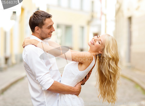 Image of smiling couple dancing in the city