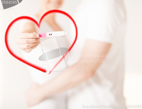 Image of woman and man hands with pregnancy test