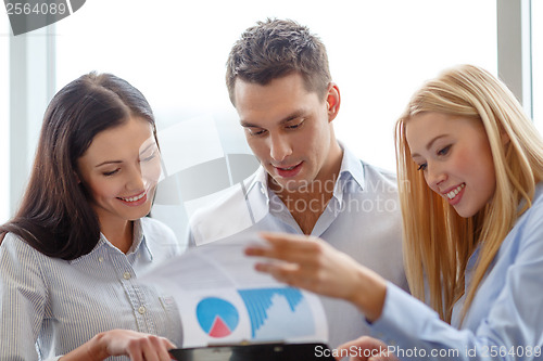 Image of business team looking at clipboard