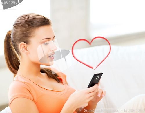 Image of woman with smartphone at home