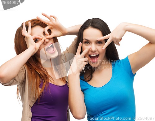 Image of two young teenagers making faces