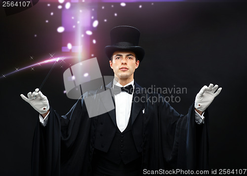 Image of magician in top hat with magic wand showing trick