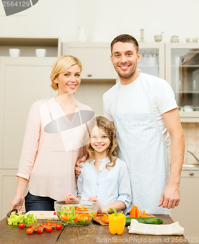 Image of happy family making dinner in kitchen