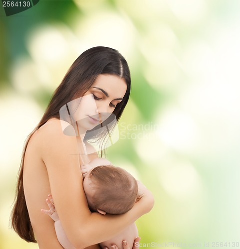 Image of happy mother feeding her adorable baby