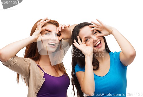 Image of two young teenagers making faces