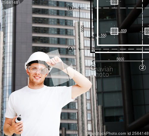 Image of male architect in white helmet with blueprint