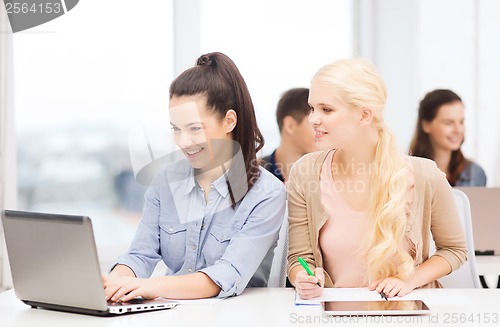 Image of students with laptop, tablet pc and notebooks