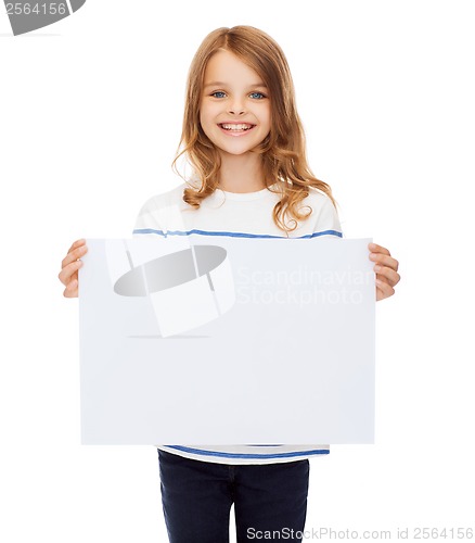 Image of smiling little child holding blank white paper