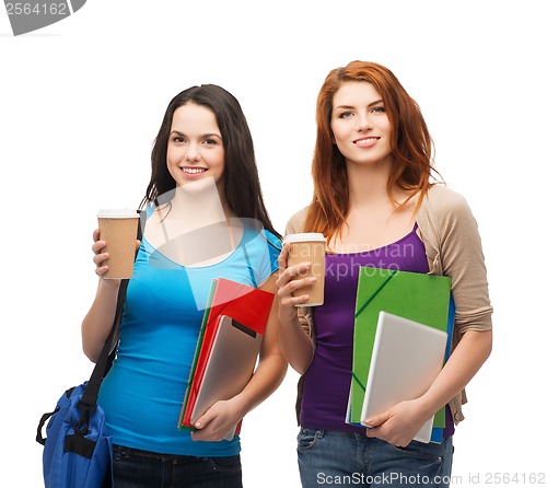 Image of two students with bag, folders, tablet and coffee