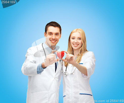 Image of smiling doctors cardiologists with heart