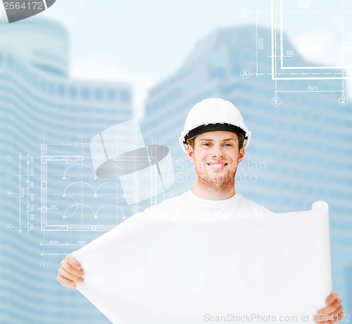 Image of male architect in white helmet with blueprint