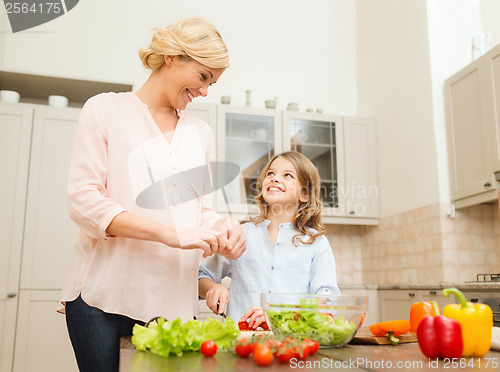 Image of happy family making dinner in kitchen