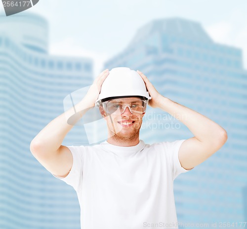 Image of male architect in helmet with safety glasses