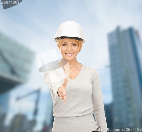 Image of contractor in helmet ready for handshake