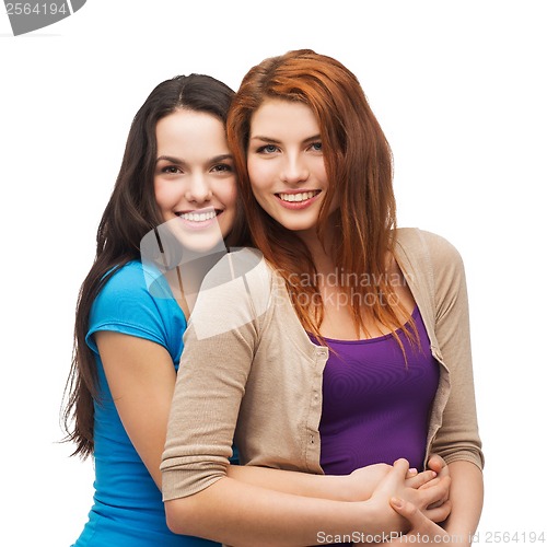 Image of two smiling girls hugging