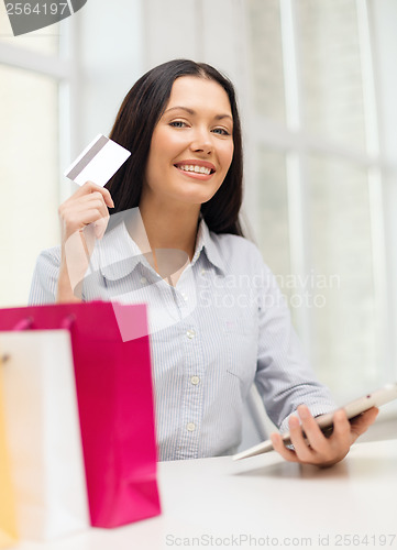 Image of smiling woman with blank screen tablet pc