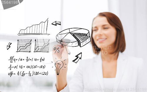 Image of businesswoman writing chart on virtual screen