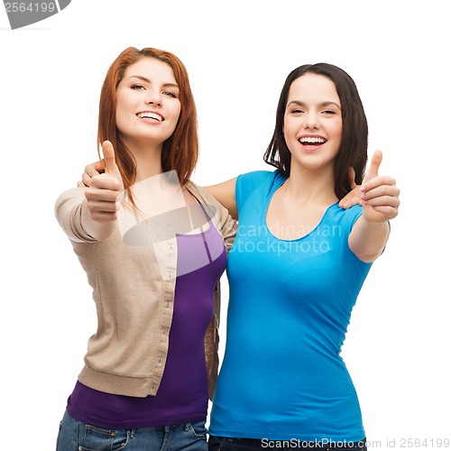 Image of two smiling girls showing thumbs up