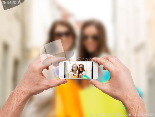 Image of close up of hands taking picture with smartphone