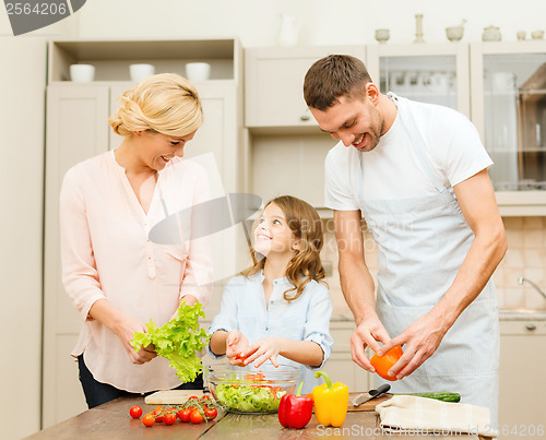 Image of happy family making dinner in kitchen