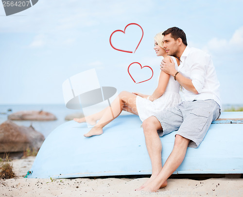 Image of couple sitting on boat at sea side