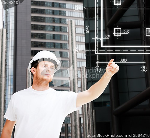 Image of male architect pointing at blueprint