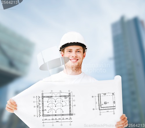 Image of male architect in white helmet with blueprint