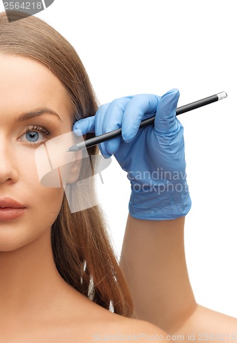 Image of woman face and beautician hands