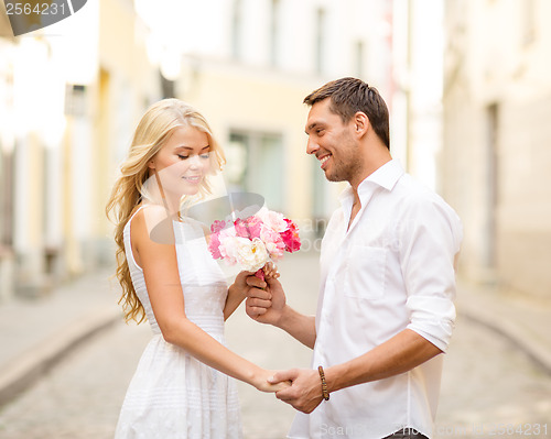 Image of couple with flowers in the city