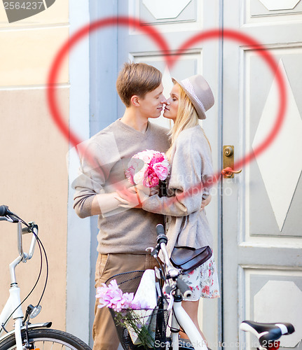 Image of couple with bicycles in the city